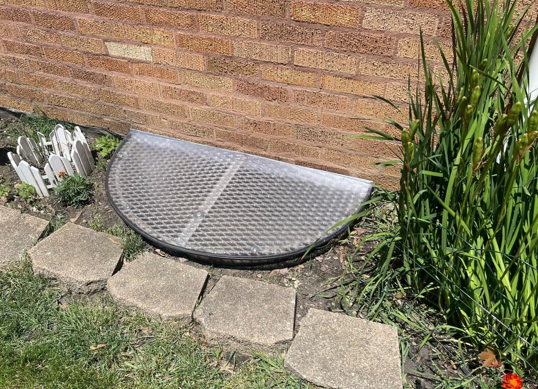 Ionized aluminum grate with sloped frosted polycarbonate window well cover installed in Evergreen Park Illinois