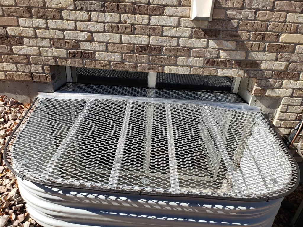 Metal custom window well cover with horizontal extension installed in Manitou Springs Colorado