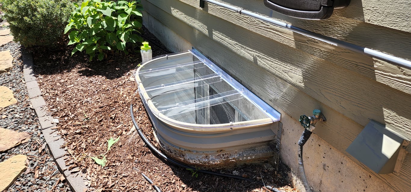 Crystal clear custom polycarbonate window well cover installed in Johnstown Colorado
