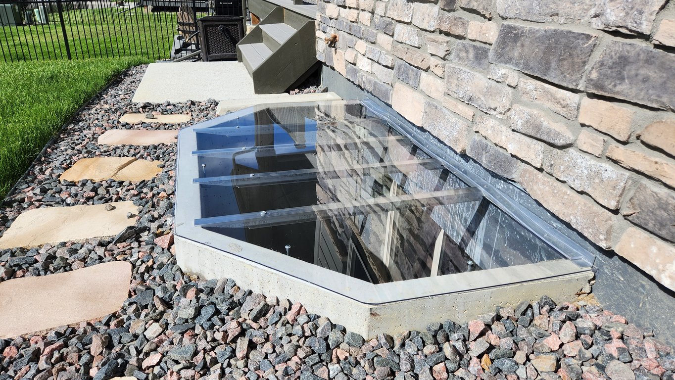 Crystal clear window well cover 75x45 installed in Oak Brook Illinois helping insulation and protection