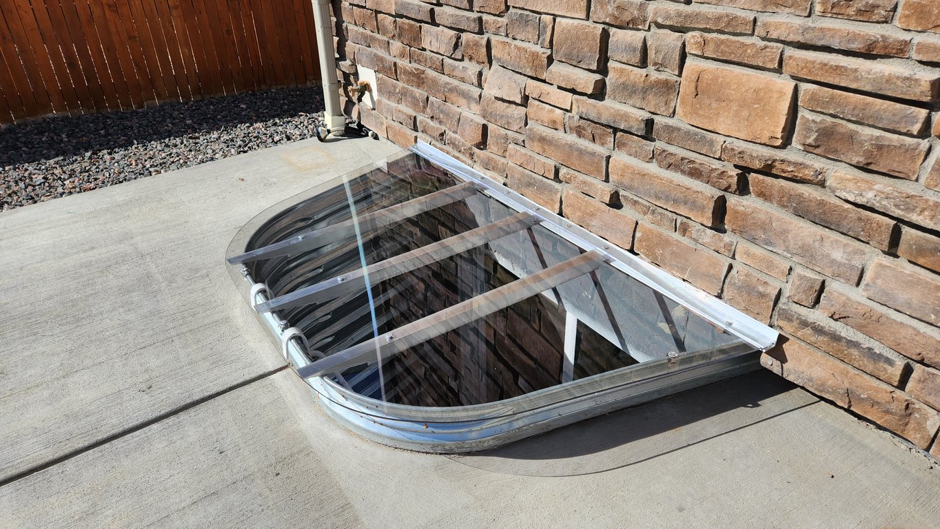 Custom window well cover installed on a patio in Wilmette Illinois