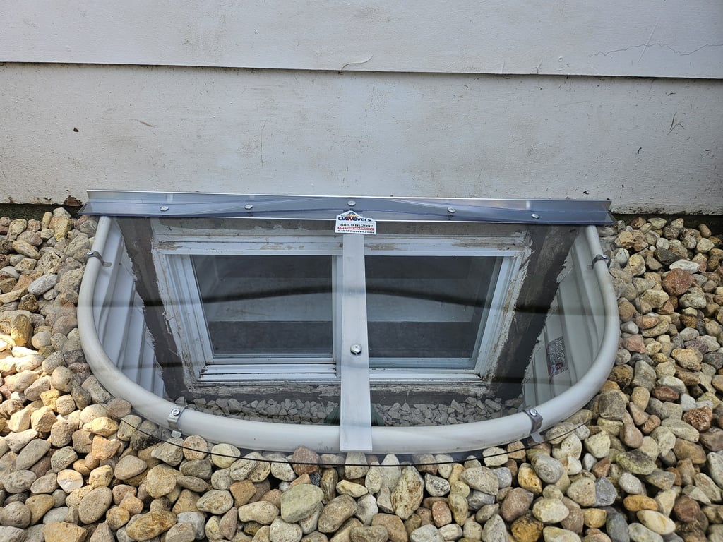 Custom clear polycarbonate window well covers made onsite and window well replacement completed in Lafayette Colorado