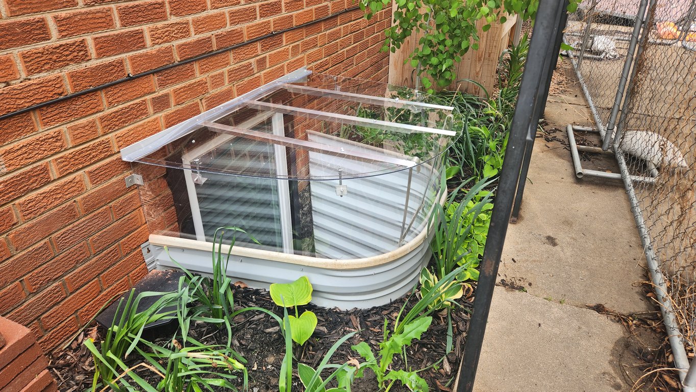 Window well extension riser with a custom window well cover with locks installed in Elmhurst Illinois