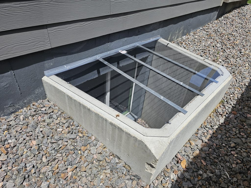 Custom clear window well cover installed on a square concrete well with clips in Rolling Meadows Illinois