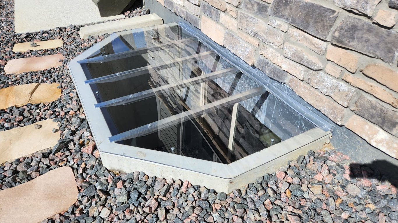 Clear polycarbonate window well cover providing weather protection in Lake Zurich Illinois