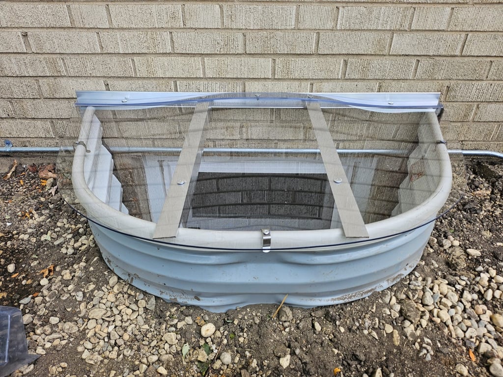 Window well replacement with a 40x20 clear polycarbonate window well cover installed in Aurora Illinois