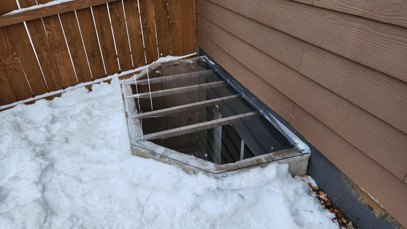 High strength clear basement window well cover with reinforced cross supports installed in Cary Illinois
