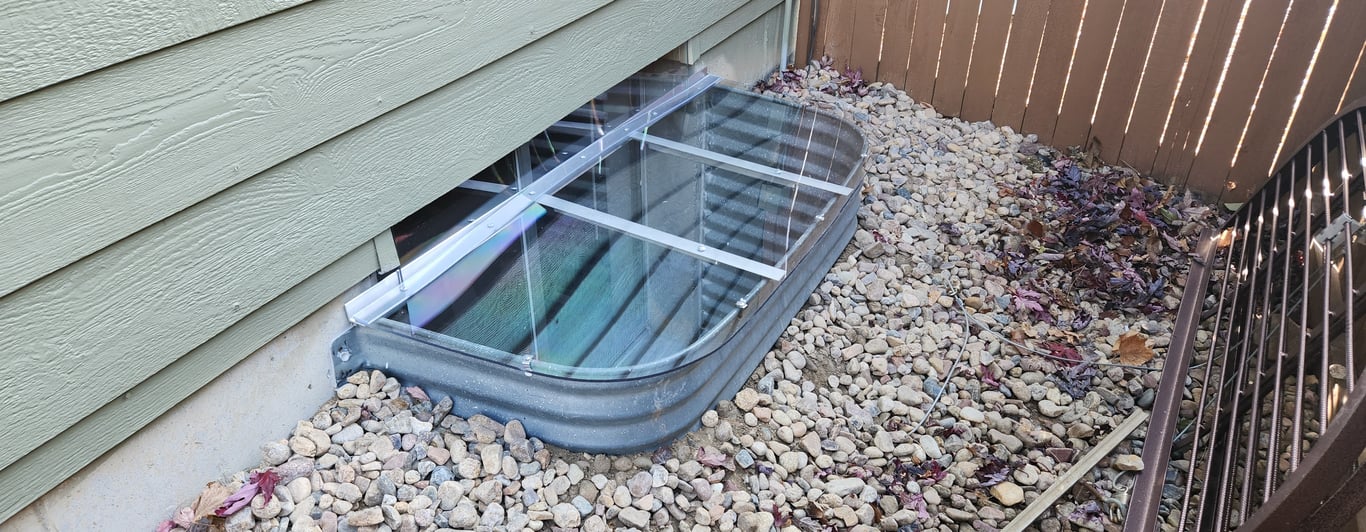Window well cover with vertical extension installed in Caledonia Wisconsin for higher basement window clearance