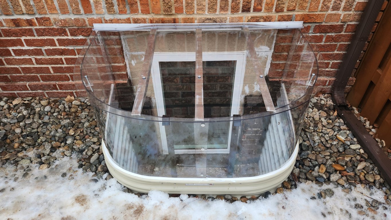 Window well cover with an extension riser and locks installed in Lisle Illinois