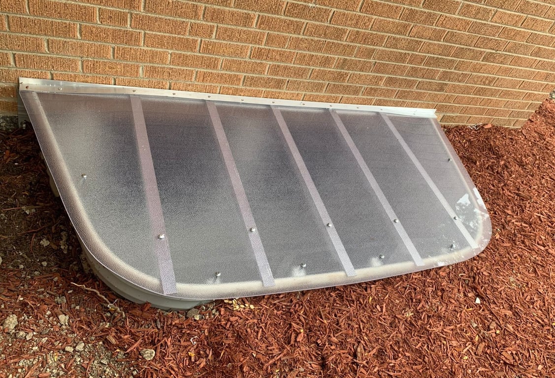 Frosted sloped window well cover with locks installed in Wheaton Illinois