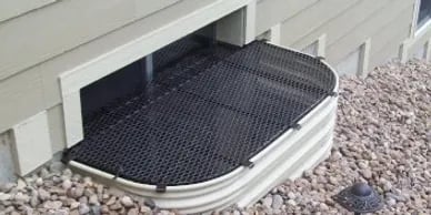 Metal window well grate 57x26 with horizontal extension powder-coated installed in Broadview Illinois