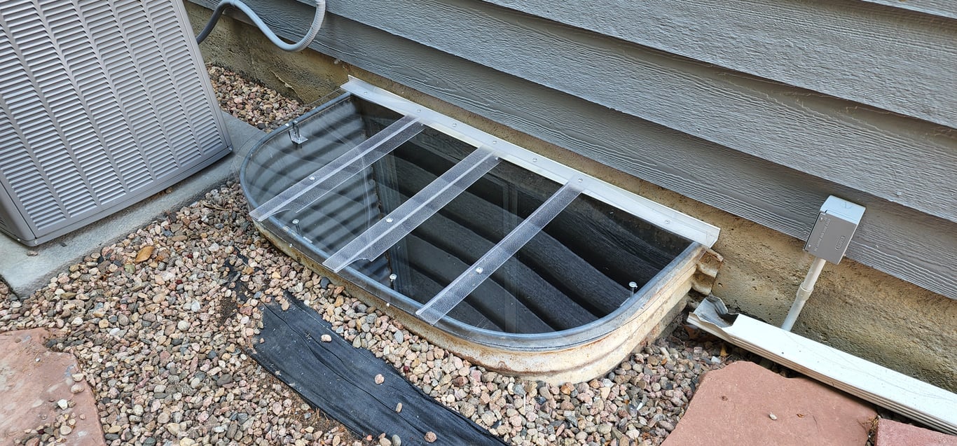 Custom crystal-clear polycarbonate window well cover built on-site for a precise fit in Elgin Illinois