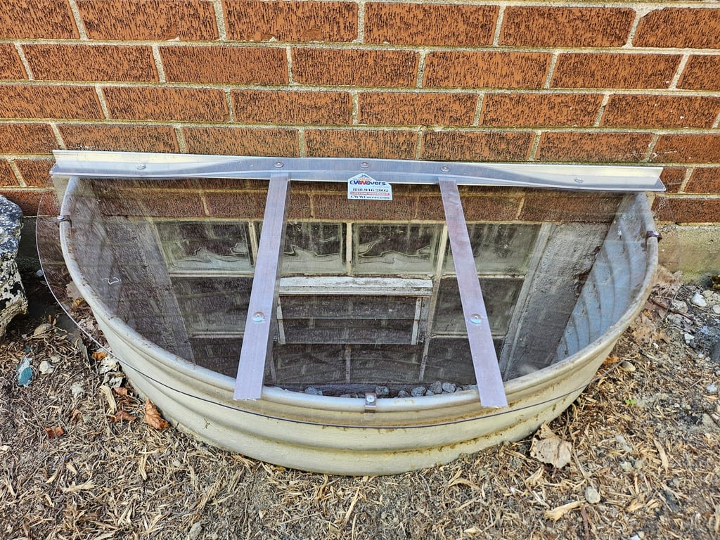 Custom clear polycarbonate window well cover installed in Highlands Ranch Colorado