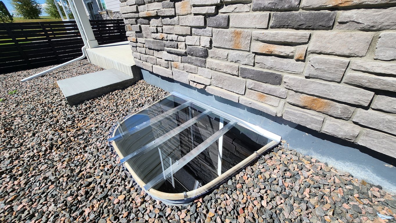 Crystal clear custom polycarbonate window well cover made onsite supporting 800 lbs installed in Forest Park Illinois