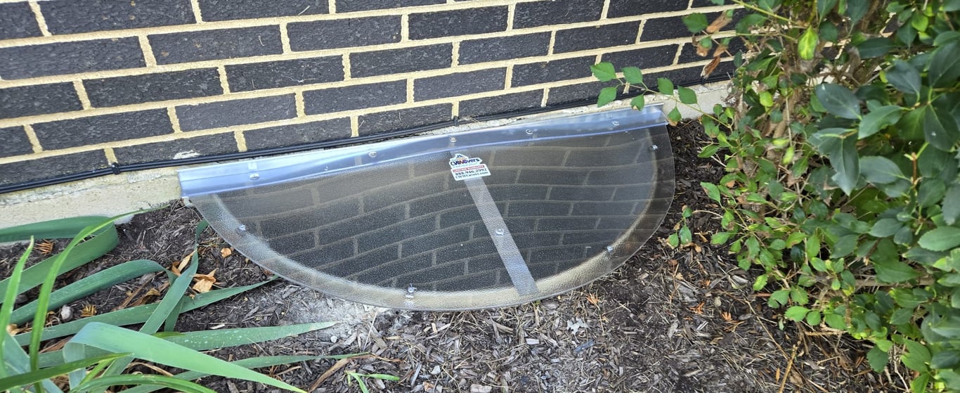 Frosted polycarbonate window well cover installed in Hobart Indiana providing privacy while allowing soft natural light