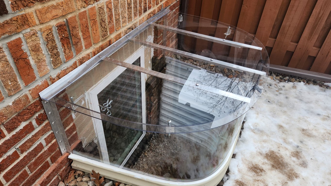 Polycarbonate extension riser with clear window well cover with locks installed in Chicago Illinois