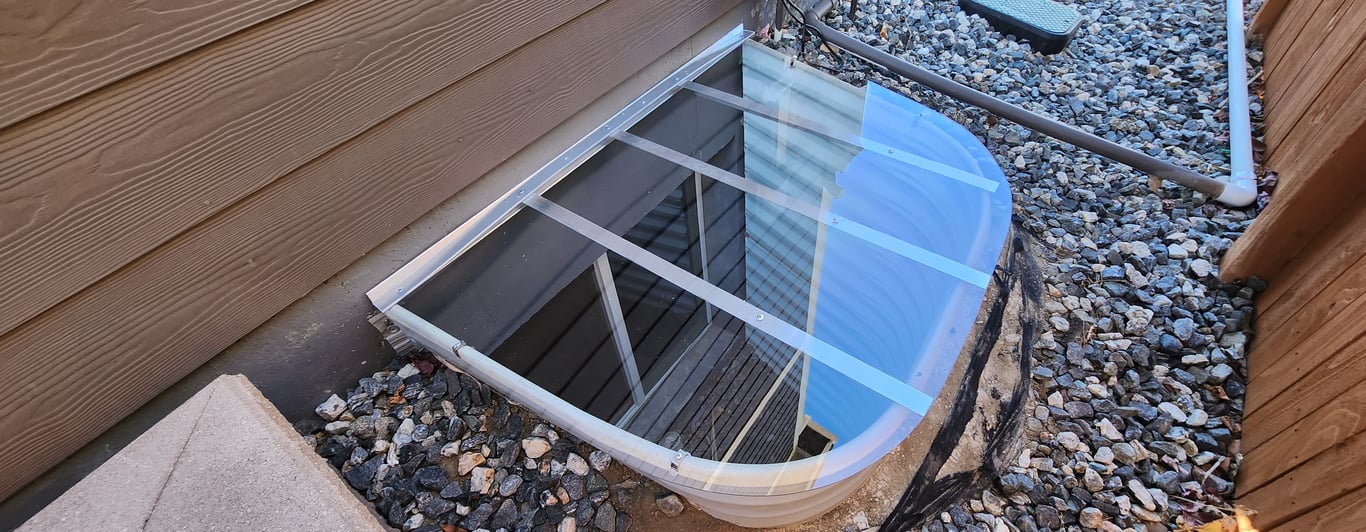 Sloped clear polycarbonate basement window well cover installed in Alsip Illinois