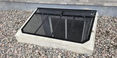 Custom metal window well cover installed in Widefield Colorado