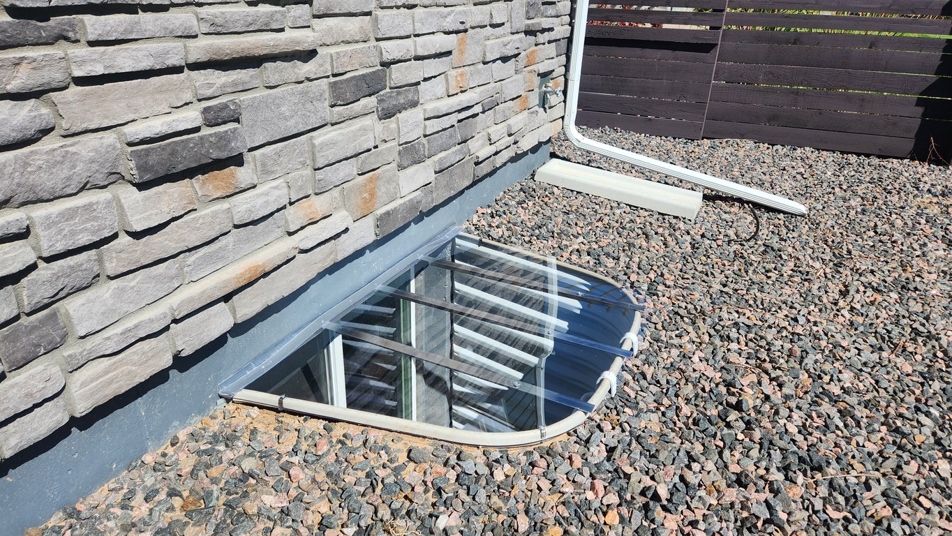 Custom window well cover installed at the back of a home in Elmhurst Illinois to keep animals out