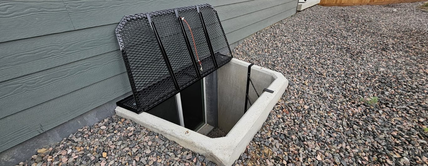 Existing metal grate window well cover in Superior Colorado before replacement with clear polycarbonate cover