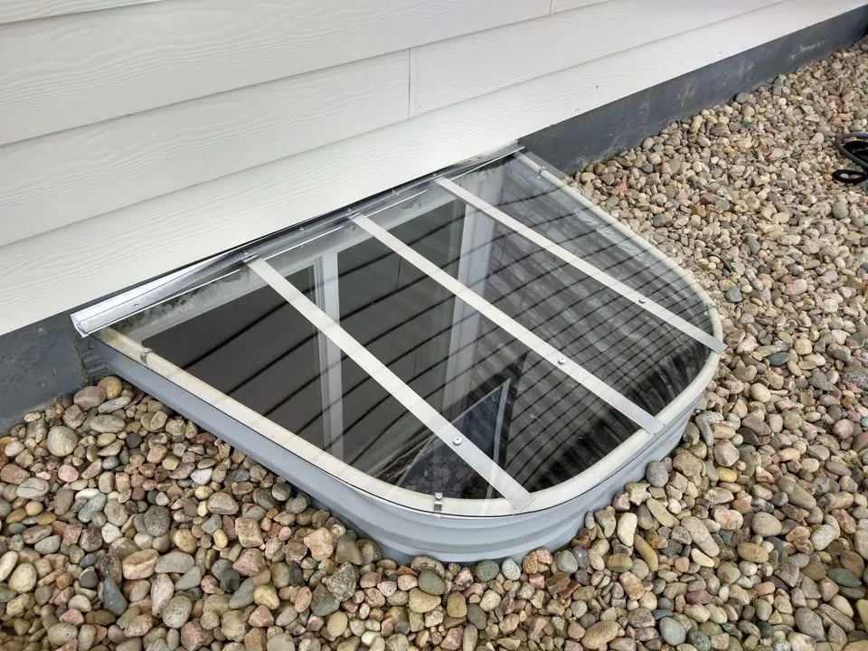 57x38 clear polycarbonate custom window well cover installed in Woodland Park Colorado