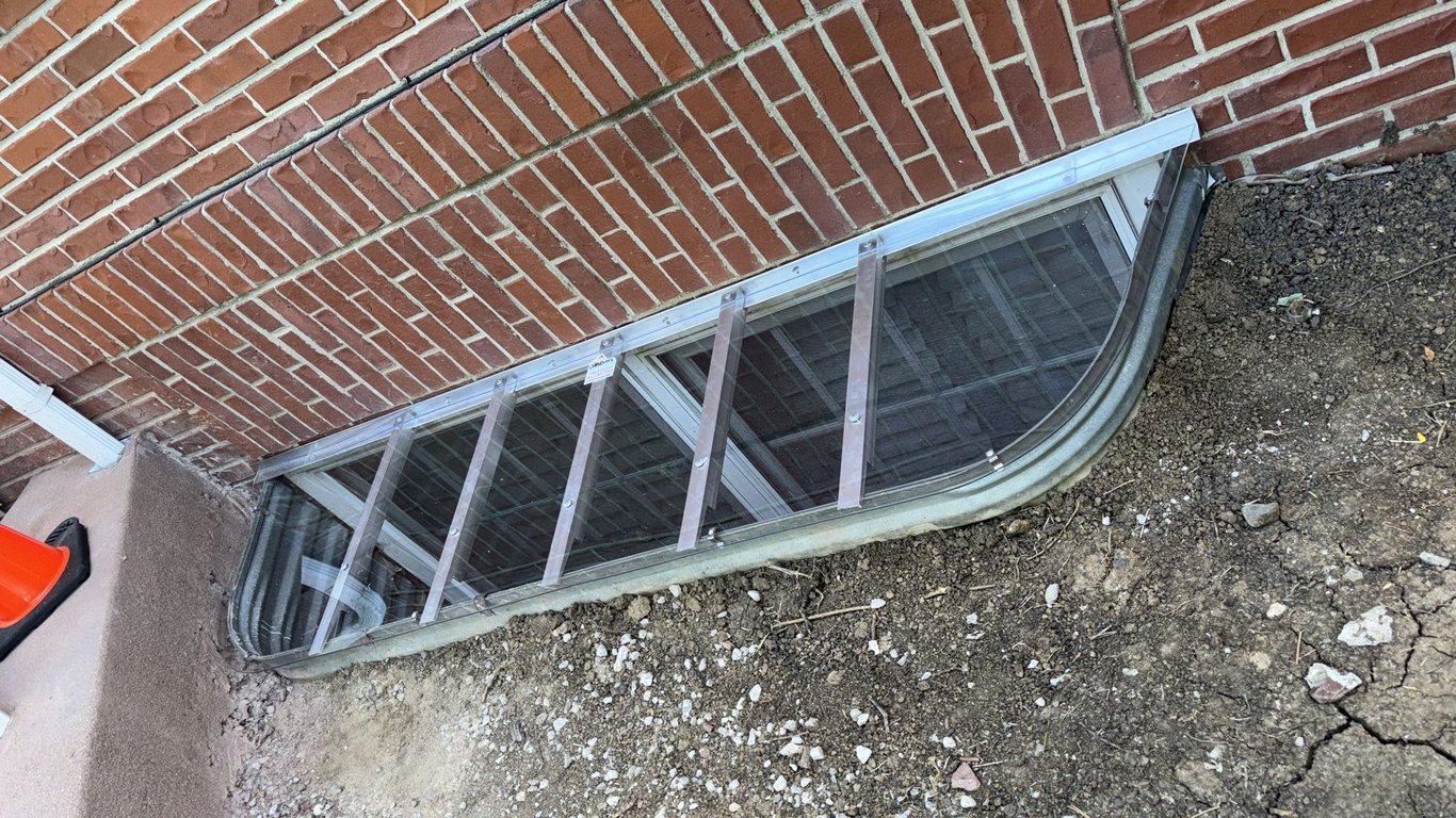Clear polycarbonate window well cover 82x18 installed in Warrenville Illinois