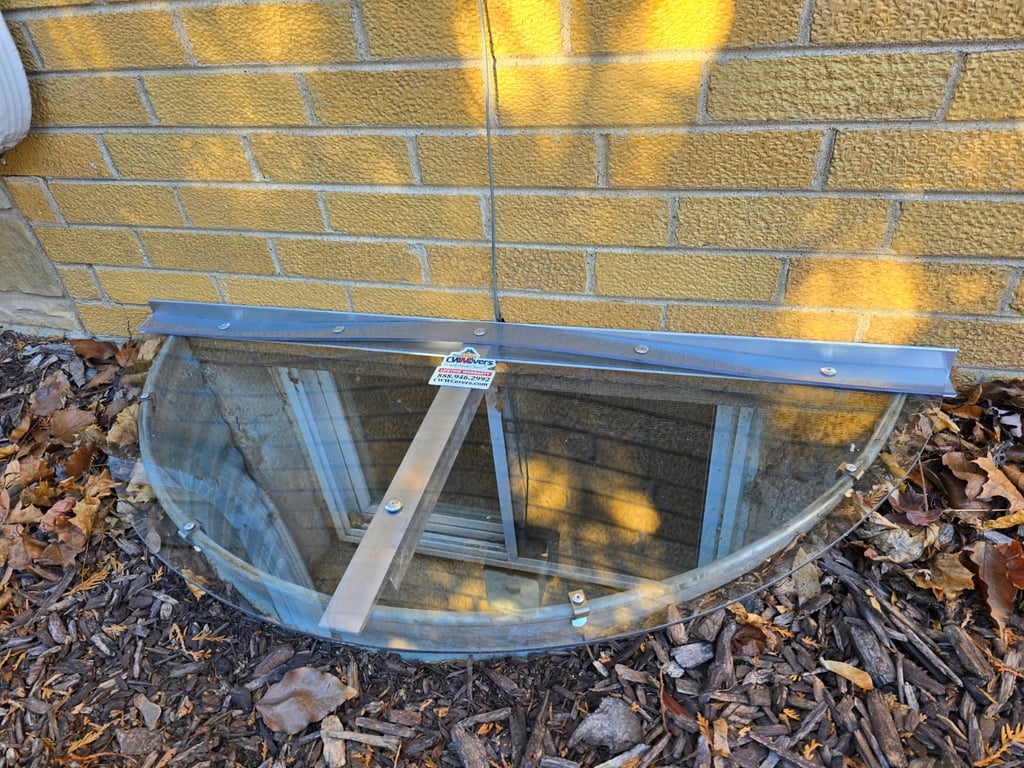 Clear polycarbonate window well cover 40x16 with clips installed in Batavia Illinois