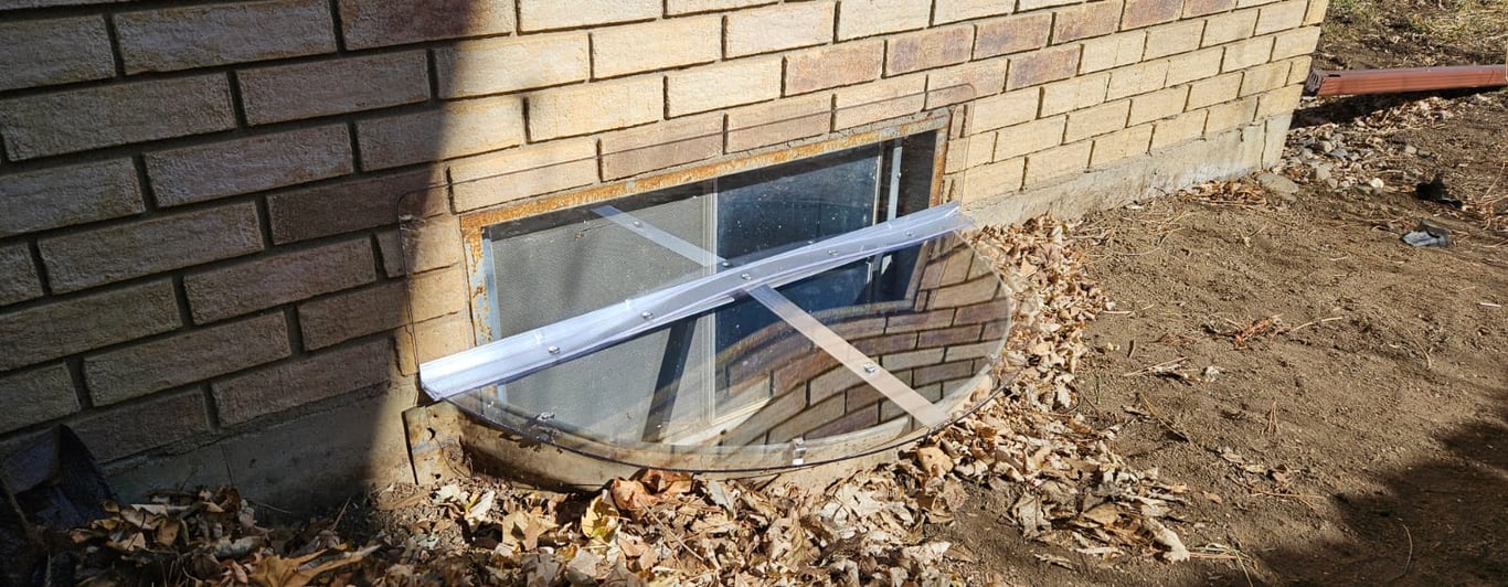 Custom clear polycarbonate window well cover with vertical extension installed in Laporte Colorado