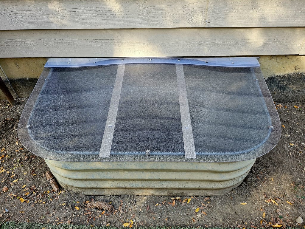 Frosted polycarbonate window well cover providing privacy while allowing soft natural light in Oswego Illinois