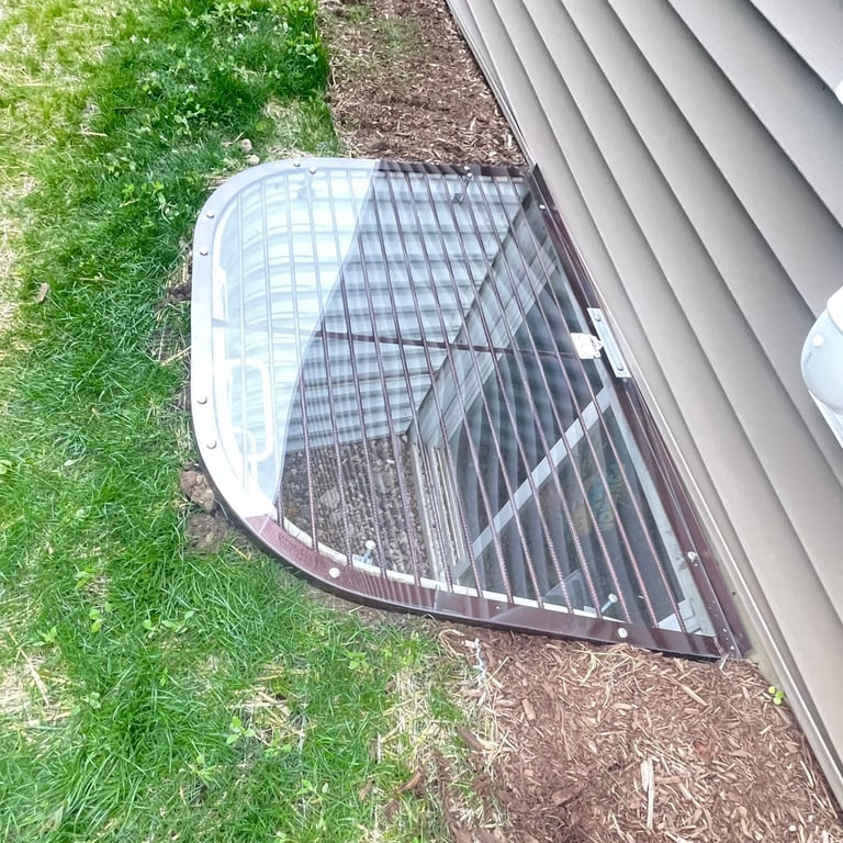 Overlay polycarbonate window well cover with locks installed on metal grate in Dolton Illinois