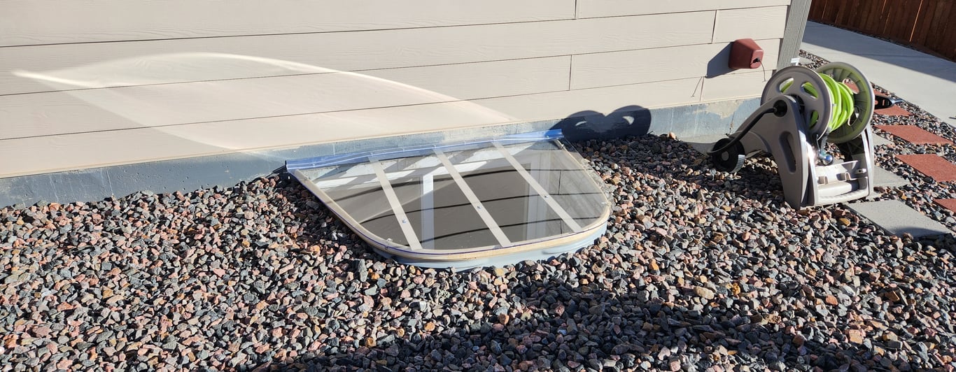 Sloped polycarbonate window well cover installed in Lincolnwood Illinois for improved drainage and protection
