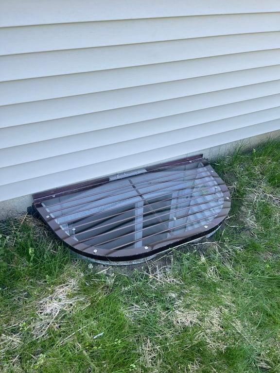 Crystal clear basement overlay window well cover installed over an existing metal grate in Lake Barrington Illinois