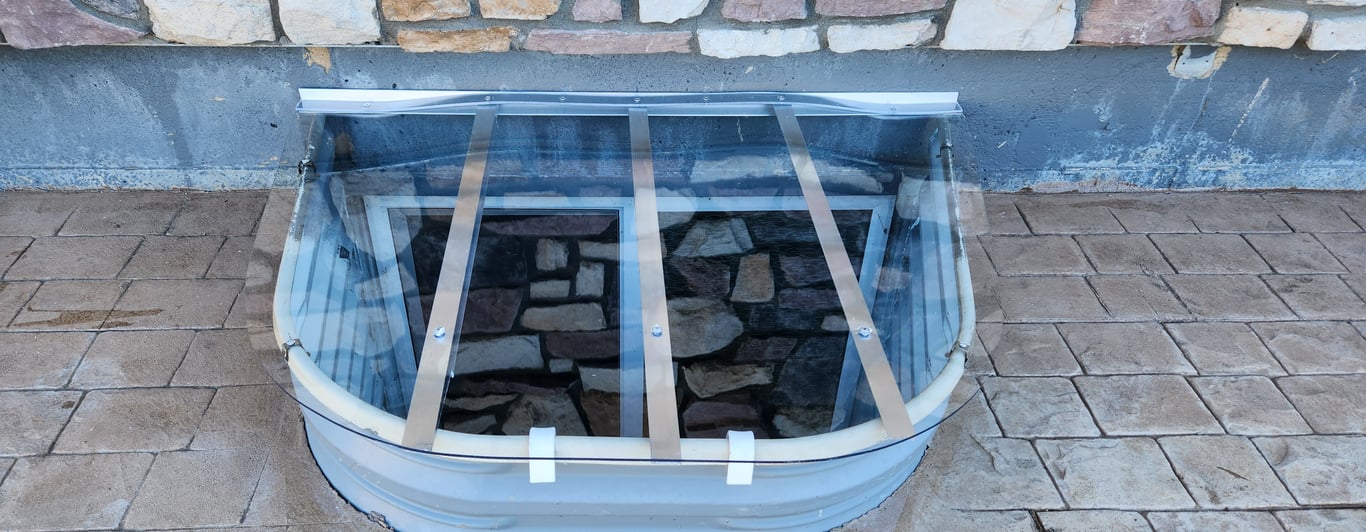 Custom crystal clear polycarbonate window well cover built on site in Orland Hills Illinois for maximum protection