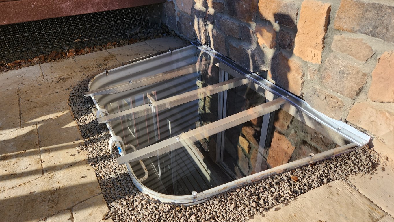 Professional window well replacement performed near Portage Indiana removing rusted wells and installing new wells
