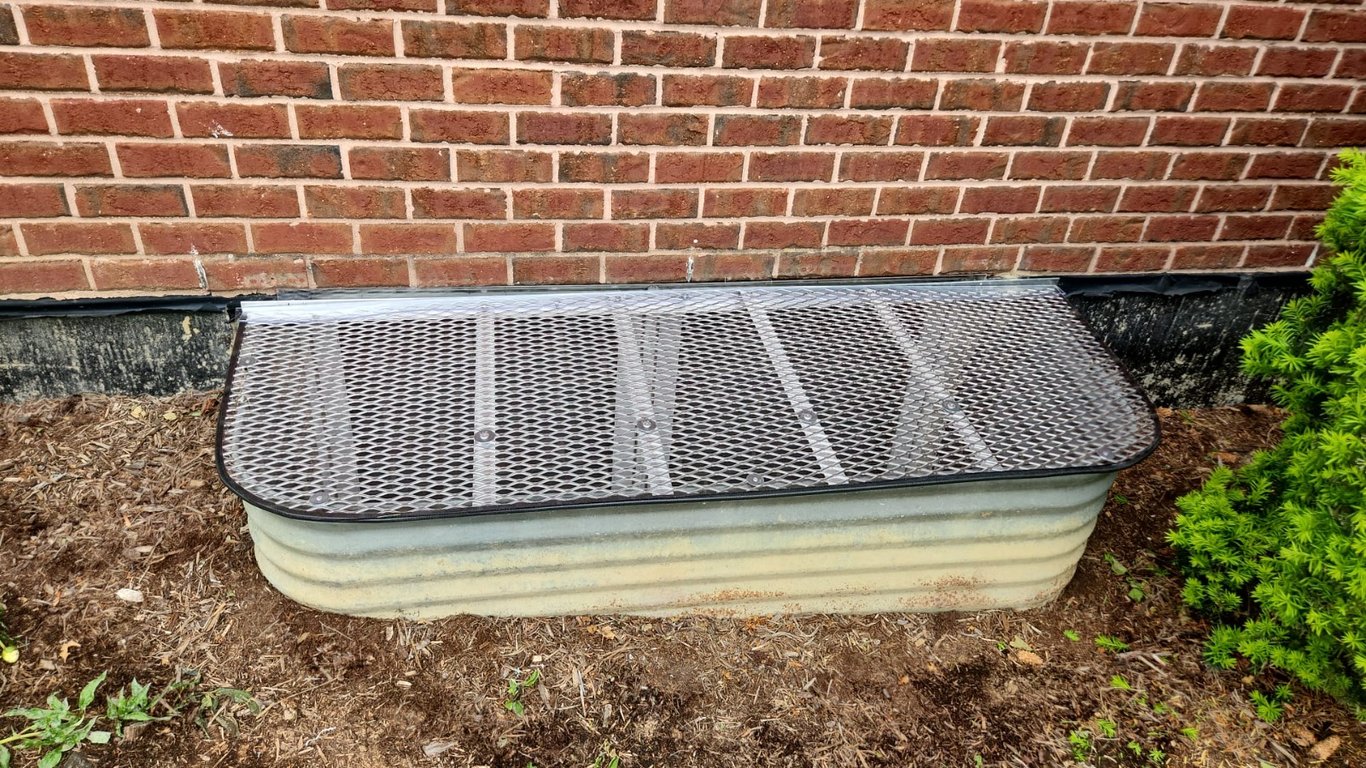 Oversize aluminum window well grate installed in backyard Oak Lawn Illinois