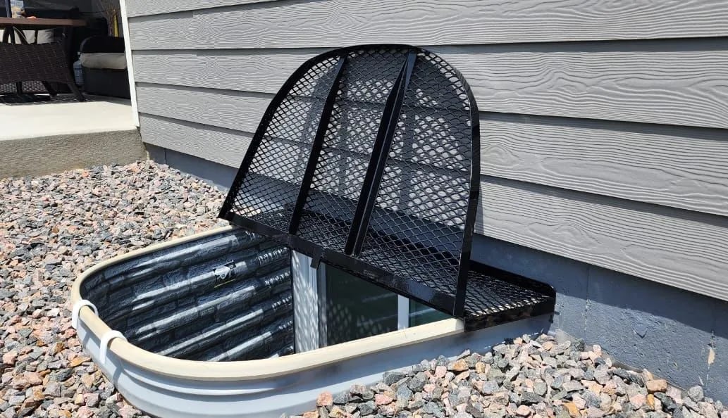 Metal window well cover with escape hatch open installed in Kenilworth Illinois