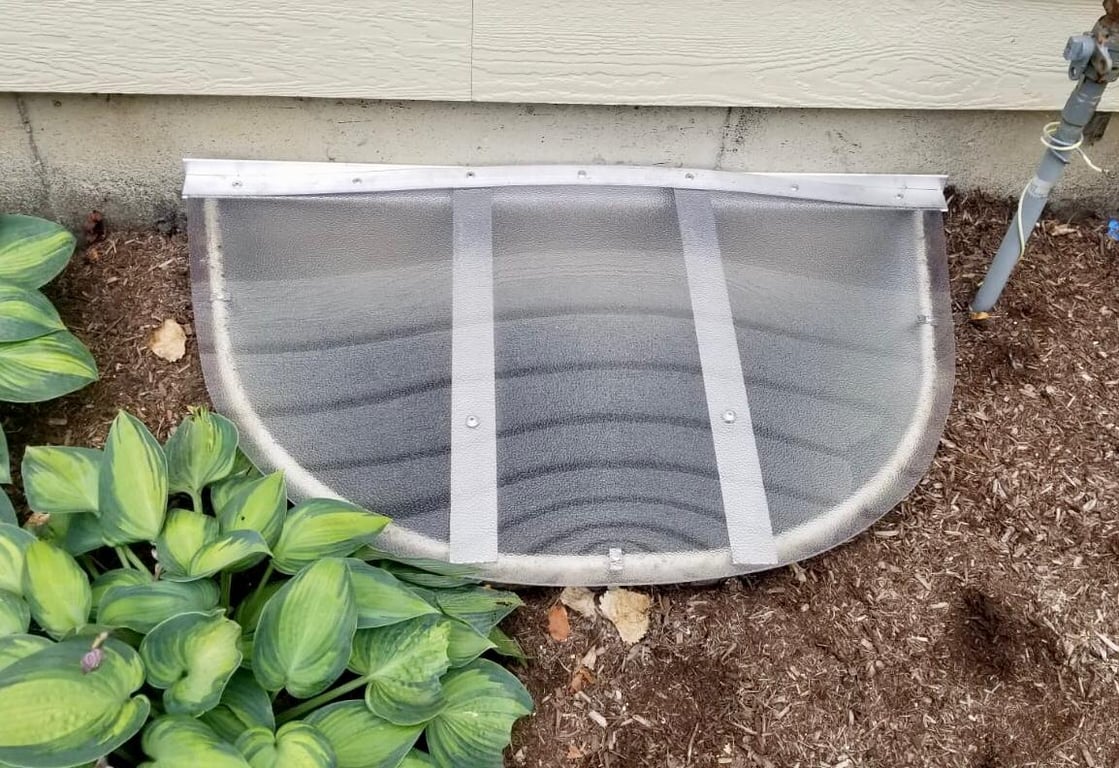 Frosted polycarbonate window well cover installed in Homer Glen Illinois engineered for heavy duty outdoor use