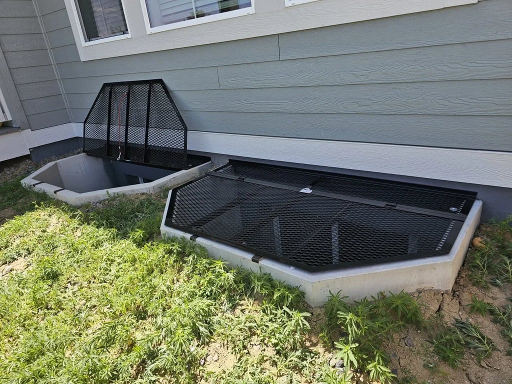 Powder coated metal window well cover with escape hatch installed in Denver Colorado