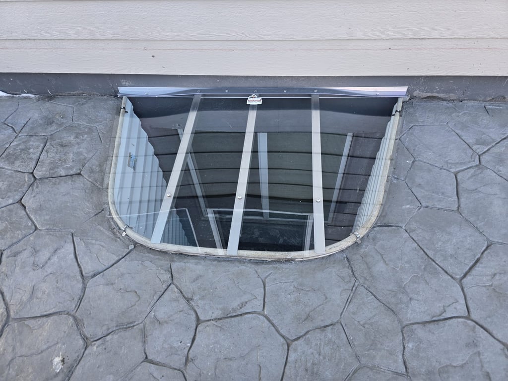 Clear polycarbonate window well cover on patio area in Harvey Illinois