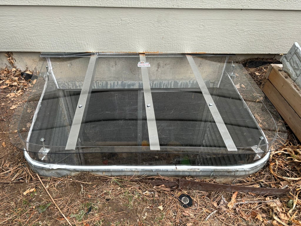 Window well cover with an extension riser installed in Aurora Illinois for a 57x38 window well