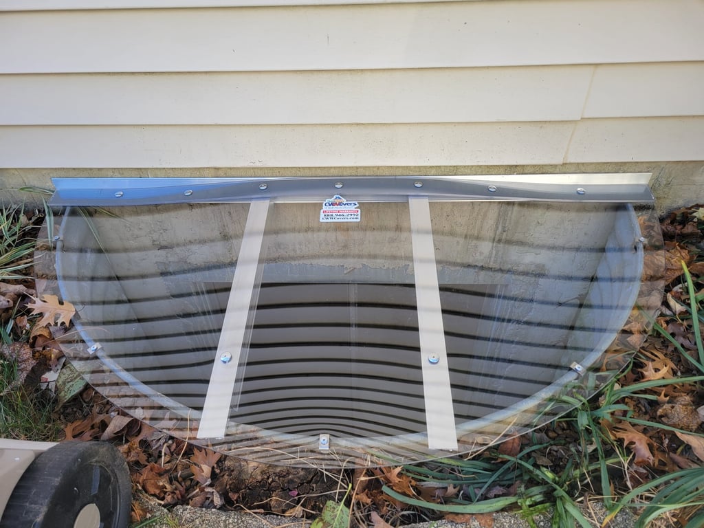 Clear polycarbonate window well cover installed near Lowell Indiana