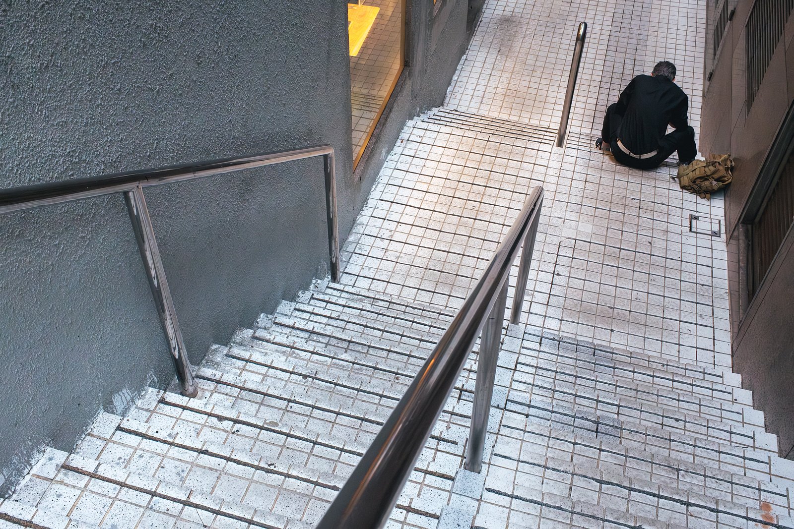 Man sitting at the bottom of stairs