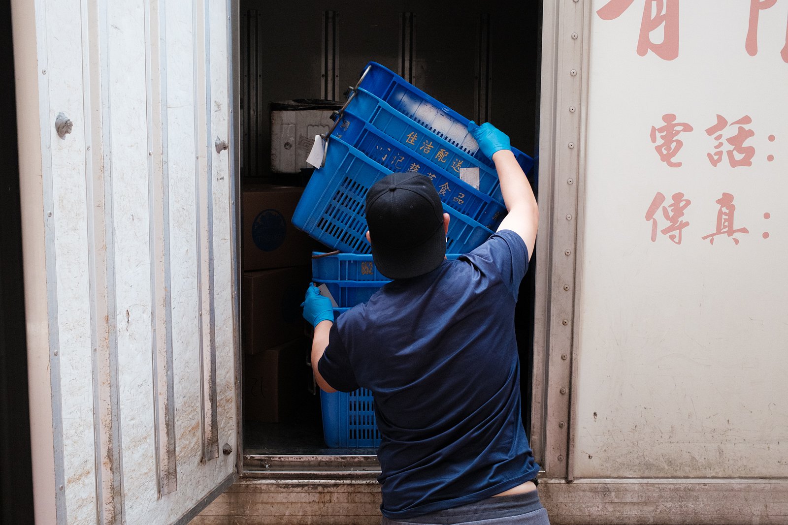 Man removing crates from van