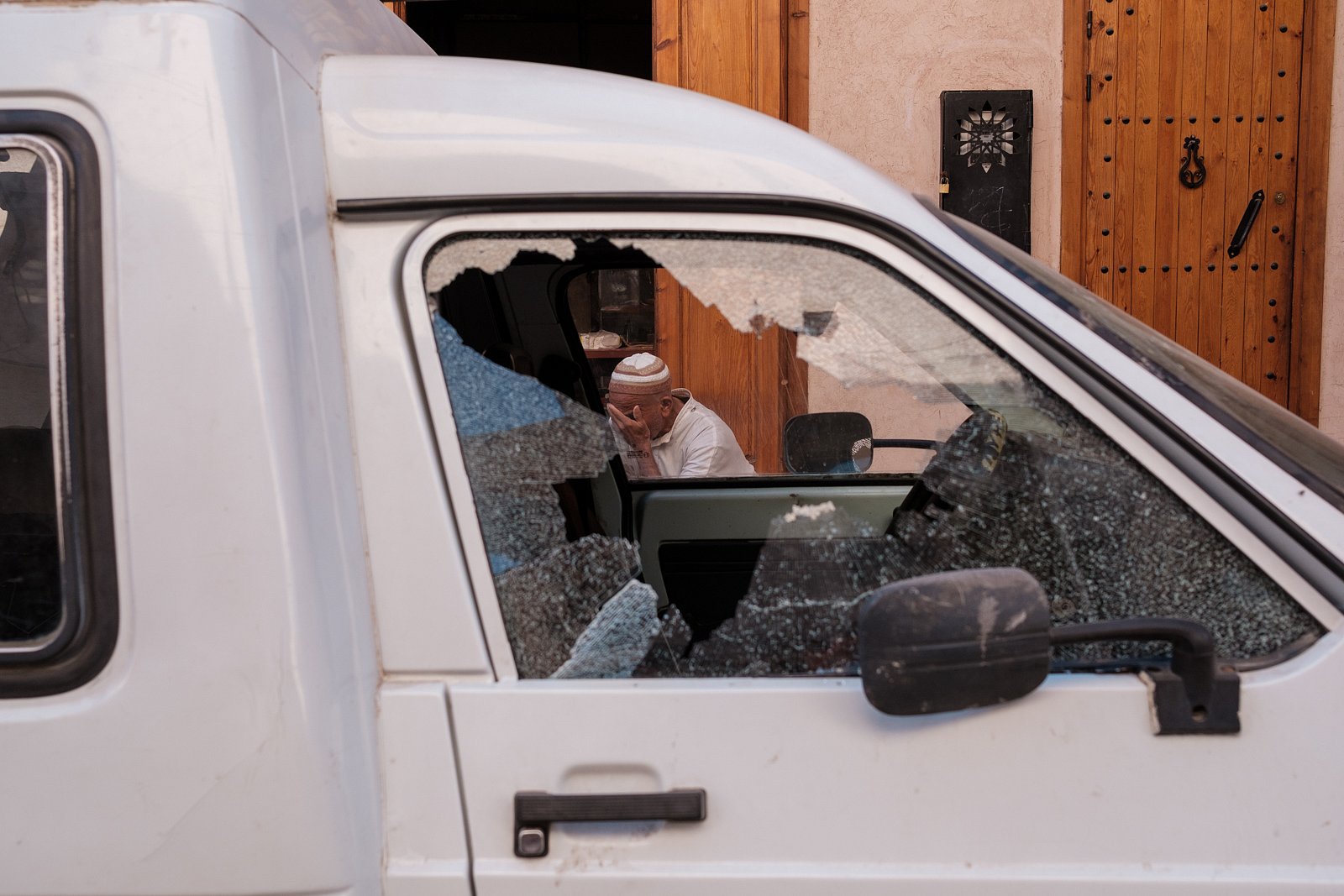 Man through broken car window