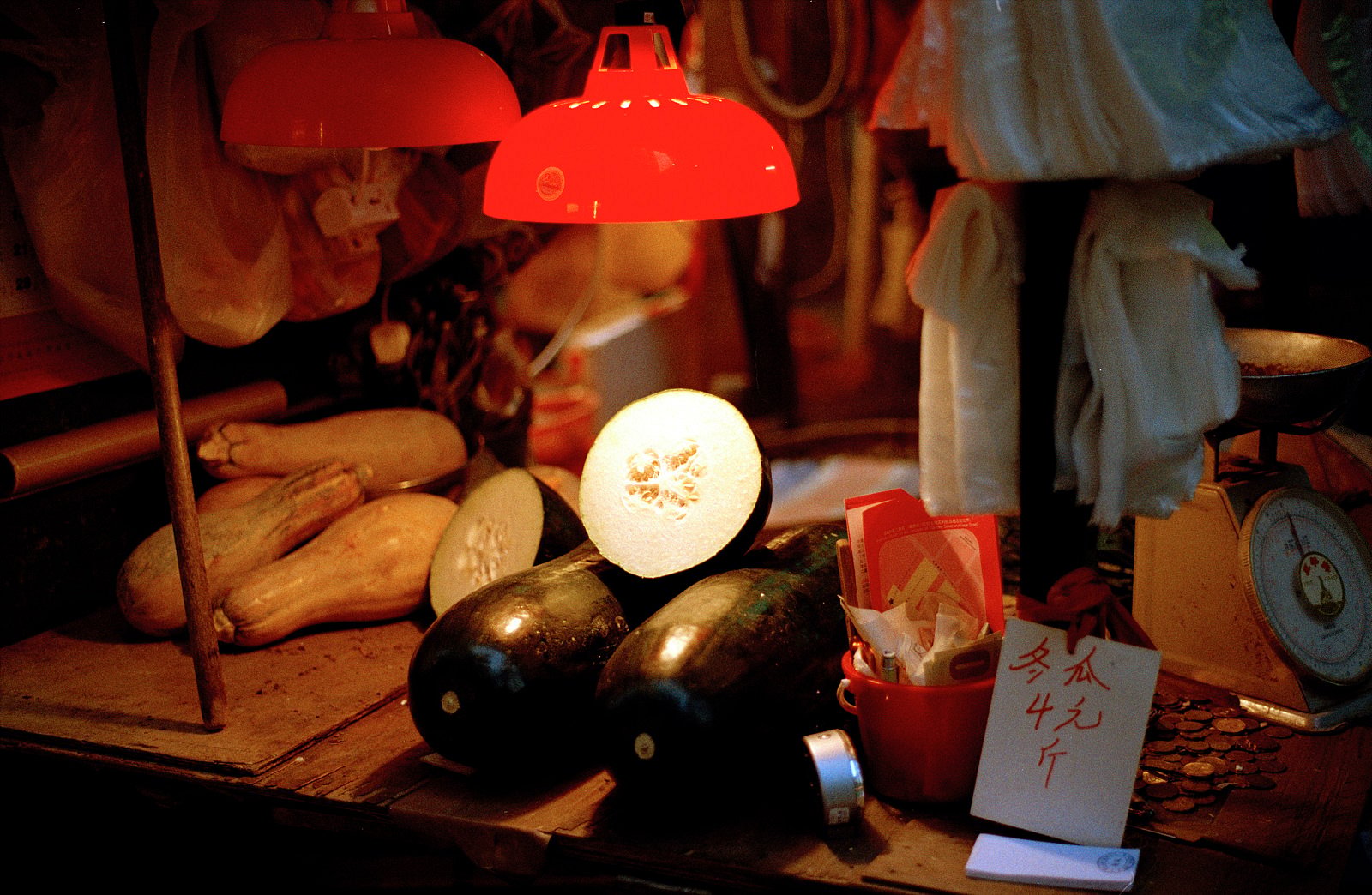 Red lamp above aubergines