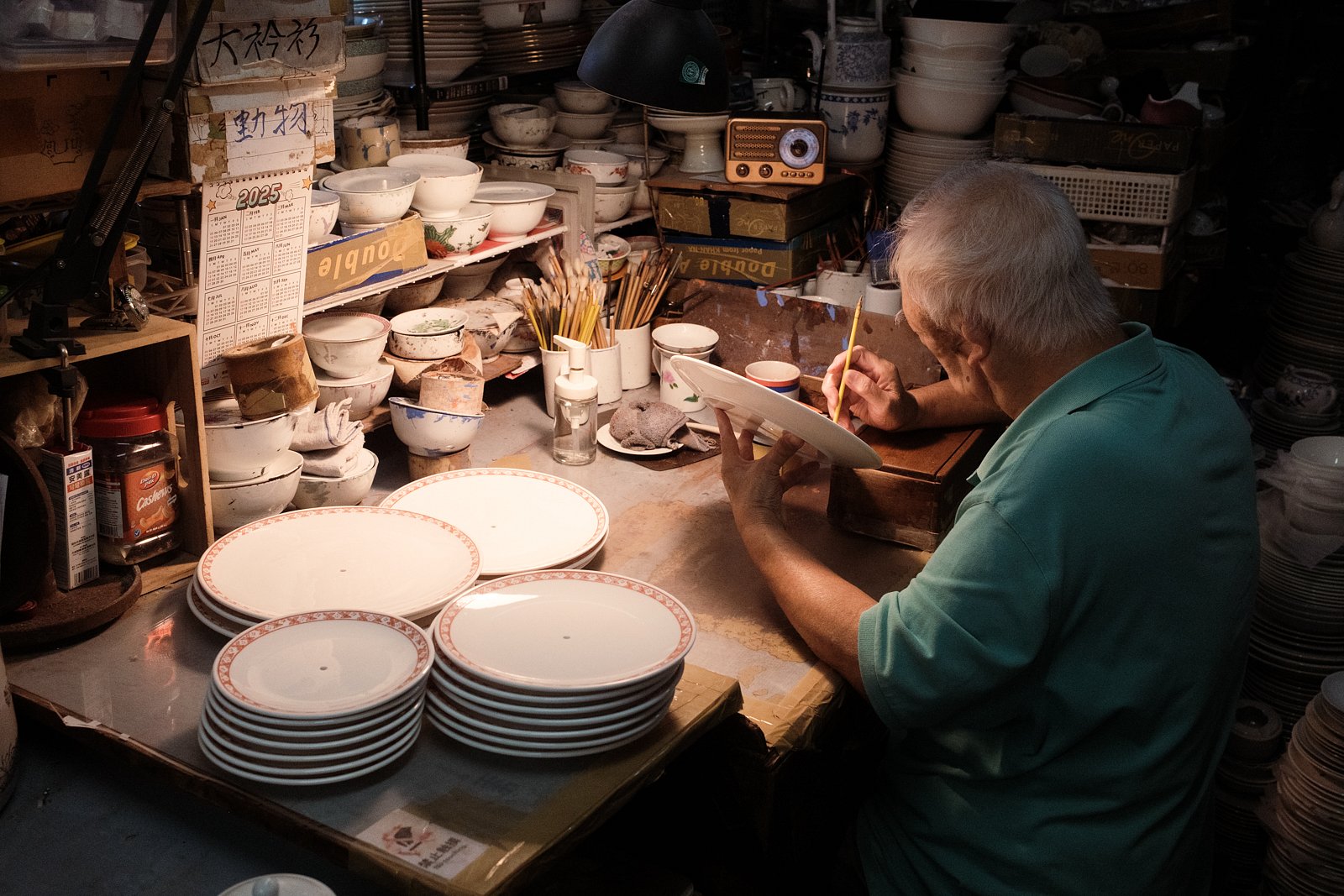 Man painting plates