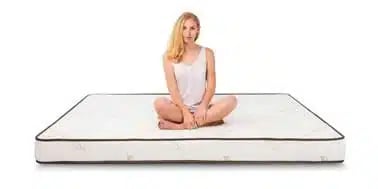 Elation Mattress with Model Sitting on Top