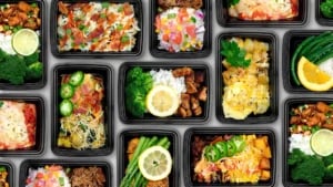 Assorted healthy meal prep containers with vegetables, proteins, and grains