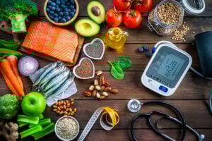 Assortment of healthy foods with medical tools promoting heart health and wellness