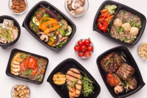A variety of fresh and healthy prepared meals including grilled chicken, vegetables, and salads, showing the wellness benefits of micro-market vending installations.